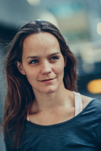 Headshot of Aislinn, a white women with long straight brown hair, blue eyes and a soft smile.